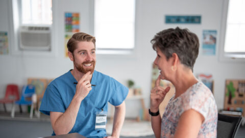 Speech therapist helping senior patient